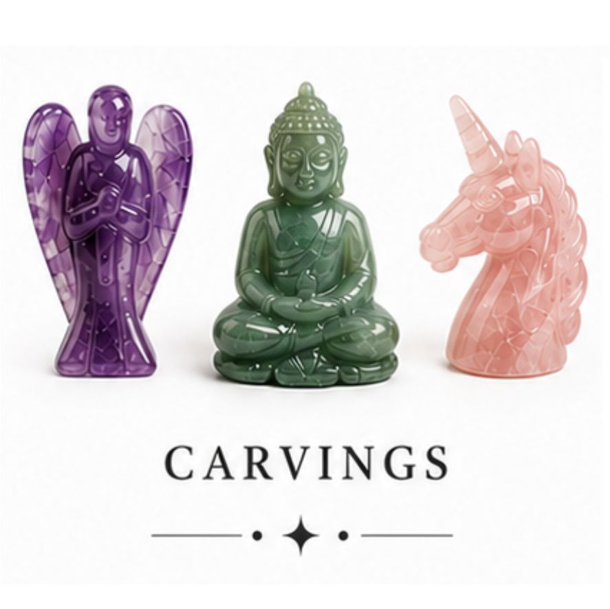 Three carved stone figurines on a white background: a purple angel, a green seated Buddha, and a pink unicorn, with the word CARVINGS below.