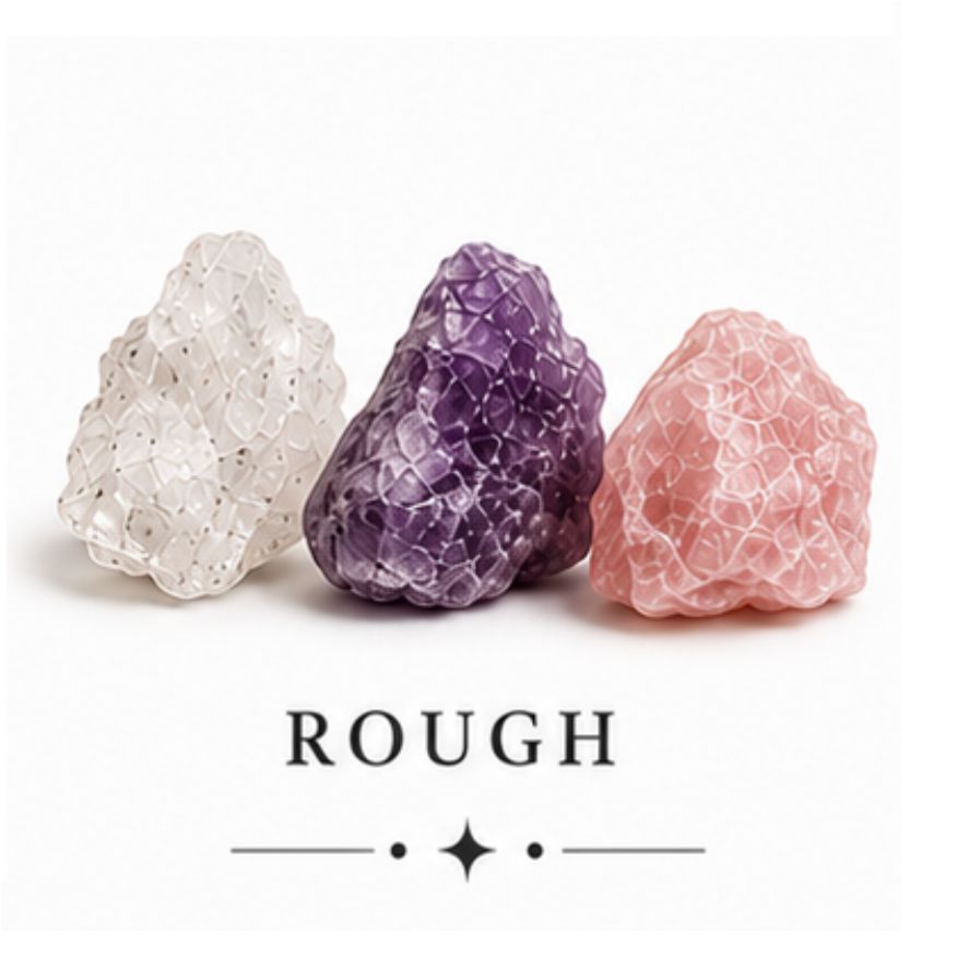Three rough crystal formations in white, purple, and pink, displayed side by side on a white background with the word 'ROUGH' printed below.
