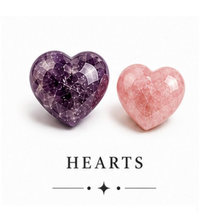 Two faceted heart-shaped beads, one purple amethyst and one pink rose quartz, displayed on a white background with the text 'HEARTS' underneath.