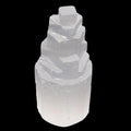 A natural selenite crystal tower with a stepped, fractal structure, shown against a solid black background.