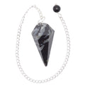A black sardonyx gemstone pendulum with a sliver chain and bead, shown on a plain white background.