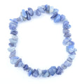 A beaded stretch bracelet made of irregular, polished blue and gray Blue Quartz chips, displayed on a clean white background.