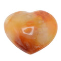A heart-shaped polished carnelian gemsont with marbled orange, amber, and pale cream tones, shown on a plain white background.
