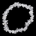 A clear quartz crystal chip bracelet made of irregular, faceted transparent stones, arranged in a circular shape against a solid black background.