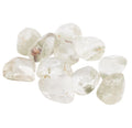 A cluster of polished garden quartz tumbled stones which are clear with inclusions, photographed on a plain white background.