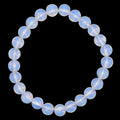 A beaded stretch bracelet made of opalite 8mm gemstone beads arranged in a circular shape against a solid black background.